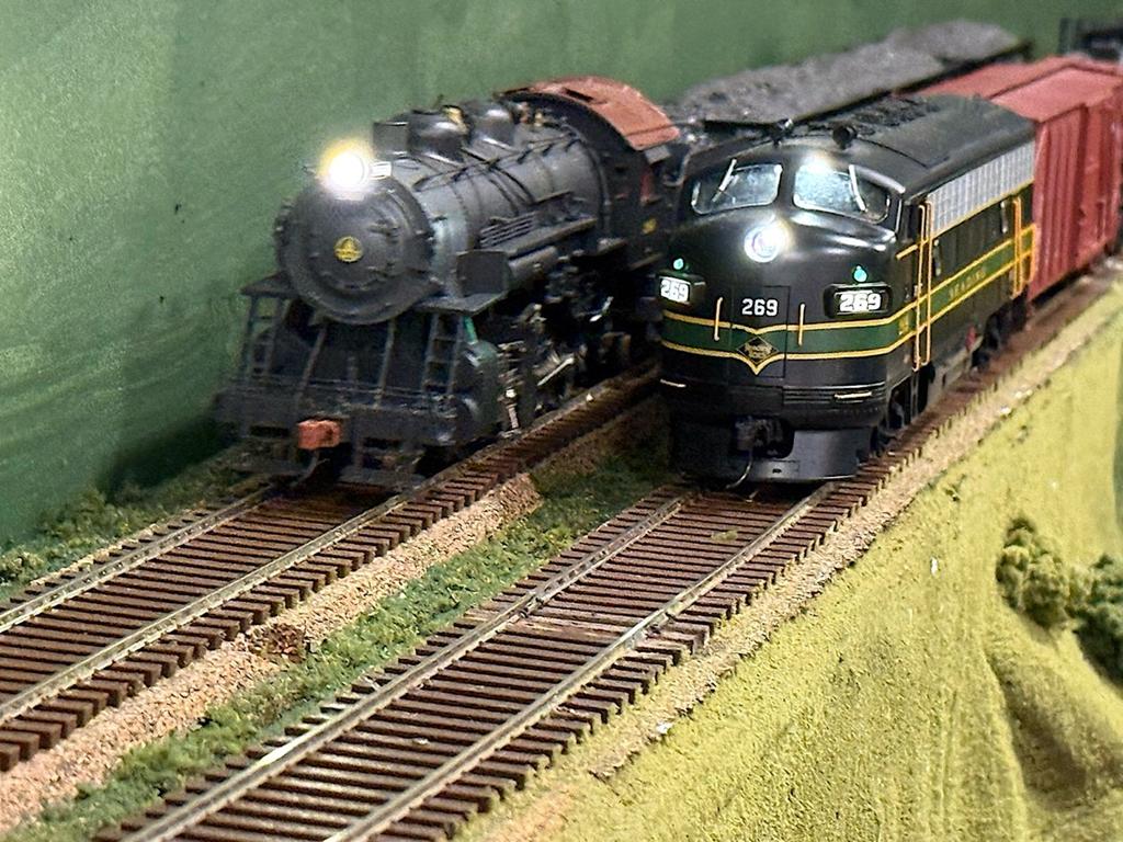 A hopper extra east with a B&O Class E, 2-8-0, passes by a local freight with Reading run-through power switching an industry along the line. There's plenty of switching and running on Mike Berus's B&O layout. (Mark Wallace photo)