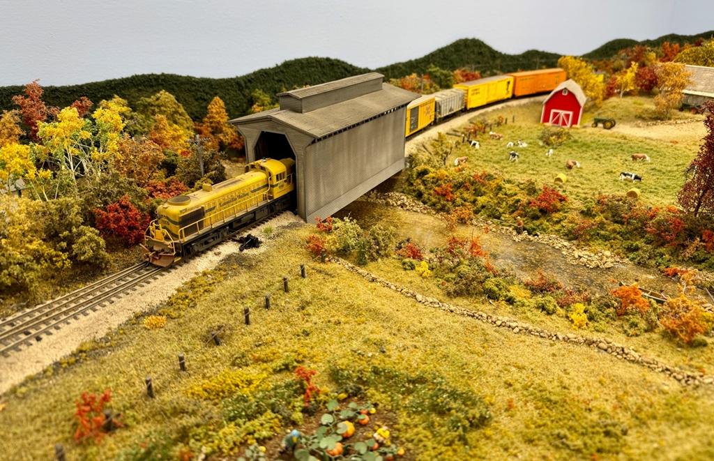Lamoille Valley train MJ-2 from Morrisville to St. Johnsbury passes through the covered bridge at Hardwick, Vermont (Mike McNamara photo)