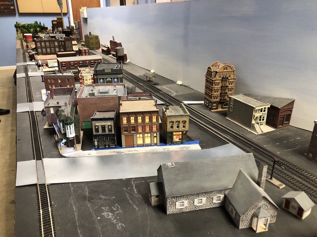 Albansburg scene looking southward. Presently under construction, but operational. Reading main line to the right and the industrial switching branch to the left. Buildings have interiors that are lighted and furnished. Modeled replica of the St. Albans Chapel in the foreground where the club is currently located (StARR/Mark Wallace photo)